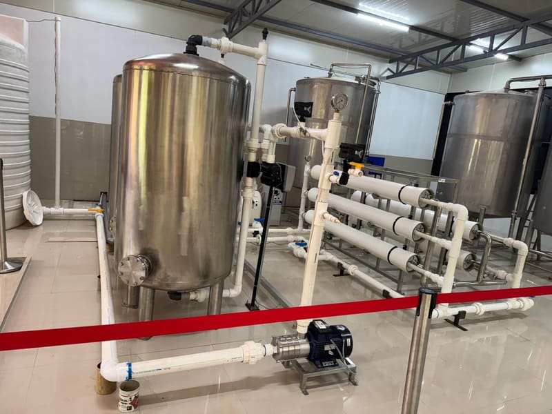 Stainless steel pressure vessels and a rack of horizontal white membrane housings with connecting pipework.